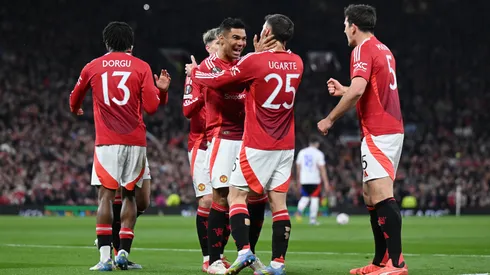 Manuel Ugarte of Manchester United celebrates scoring his team's first goal with teammate Casemiro during the UEFA Europa League 2024/25 Quarter Final Second Leg match between Manchester United and Olympique Lyonnais.