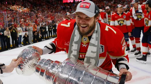 Dmitry Kulikov #7 of the Florida Panthers celebrates with the Stanley Cup following a 2-1 victory over the Edmonton Oilers in Game Seven of the 2024 NHL Stanley Cup Final.