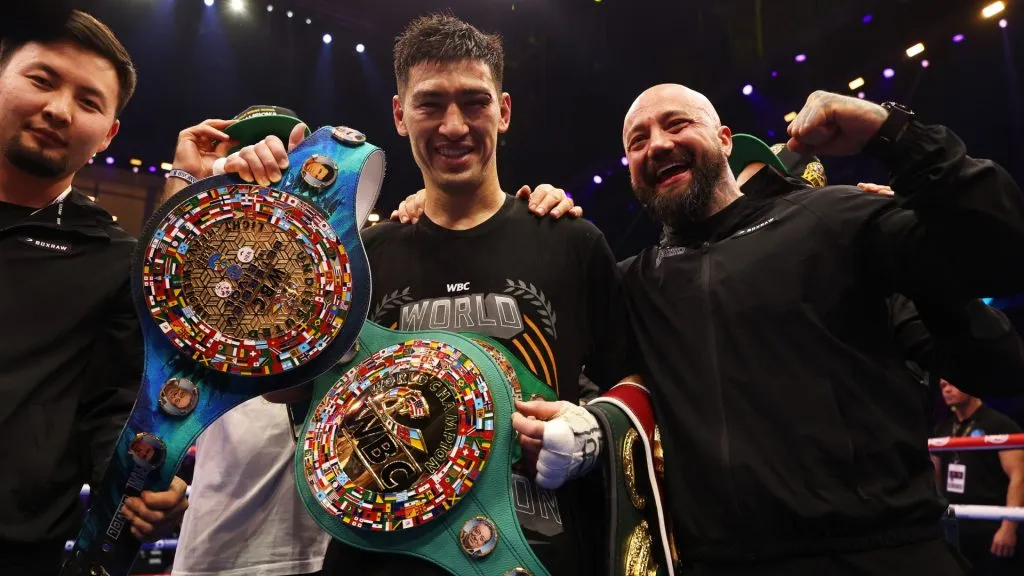 Dmitrii Bivol celebrates victory with the title belts and his team after the Undisputed IBF, IBO, WBC and WBO World Light Heavyweight Titles’ fight between Artur Beterbiev and Dmitrii Bivol as part of Beterbiev v Bivol 2. (Photo by Richard Pelham/Getty Images)