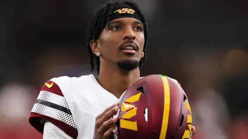 Jayden Daniels #5 of the Washington Commanders looks on during the second half against the Arizona Cardinals at State Farm Stadium on September 29, 2024 in Glendale, Arizona.