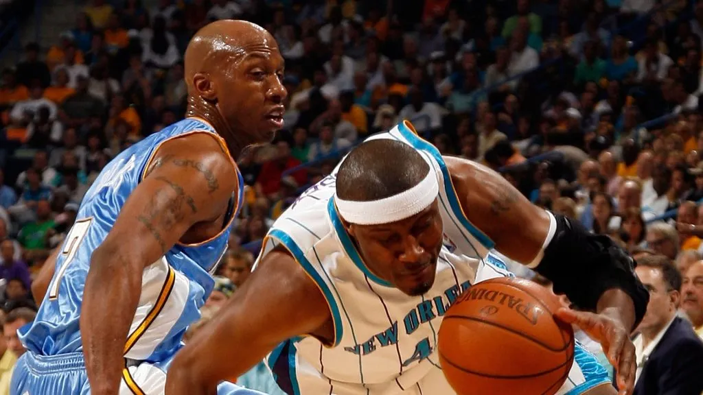Chauncey Billups #7 of the Denver Nuggets watches as James Posey #41 of the New Orleans Hornets falls to the ground in Game Four of the Western Conference Quarterfinals during the 2009 NBA Playoffs at New Orleans Arena on April 27, 2009 in New Orleans, Louisiana.
