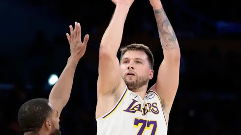 Luka Doncic #77 of the Los Angeles Lakers takes a shot over Mike Conley #10 of the Minnesota Timberwolves