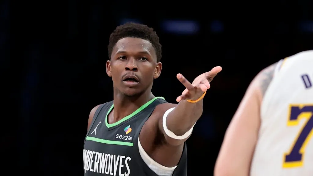 Anthony Edwards reacts in front of Luka Doncic