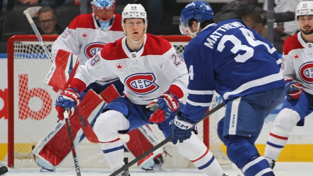 Christian Dvorak #28 of the Montreal Canadiens defends against Auston Matthews #34 of the Toronto Maple Leafs during the third period of an NHL game at Scotiabank Arena on April 12, 2025 in Toronto, Ontario, Canada. (Photo by Claus Andersen/Getty Images)