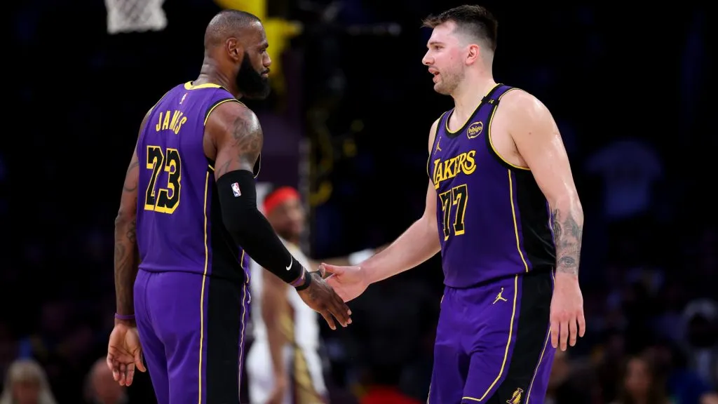 LeBron James #23 and Luka Doncic #77 of the Los Angeles Lakers shake hands against the New Orleans Pelicans. (Luke Hales/Getty Images)