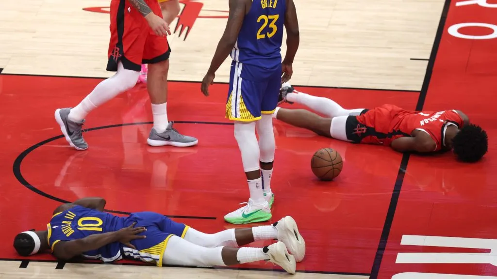Jimmy Butler III and Amen Thompson lay on the ground during the first quarter in Game Two of the Western Conference First Round NBA Playoffs.