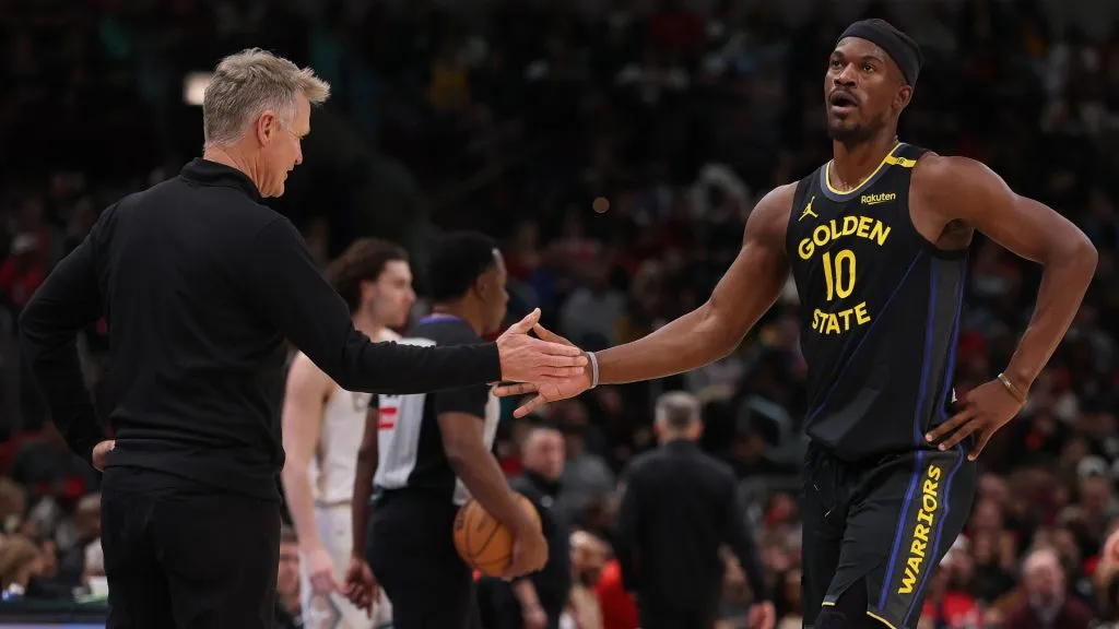 Head coach Steve Kerr of the Golden State Warriors high fives Jimmy Butler #10