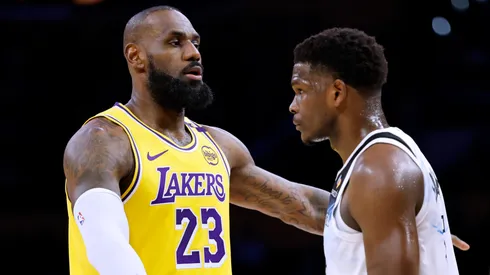 LeBron James #23 of the Los Angeles Lakers directs a play as he is guarded by Anthony Edwards #5 of the Minnesota Timberwolves.