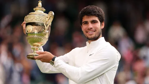 Carlos Alcaraz of Spain holds the Men's Singles Trophy following his victory in the 2023 Wimbledon.