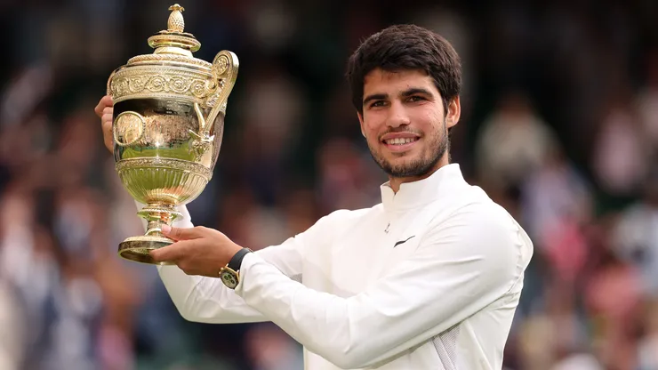 Carlos Alcaraz of Spain holds the Men's Singles Trophy following his victory in the 2023 Wimbledon.
