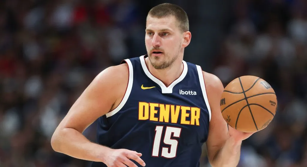 Nikola Jokic handing a ball with Denver nuggets