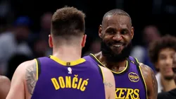 Luka Doncic #77 embraces LeBron James #23 of the Los Angeles Lakers during the fourth quarter against the Dallas Mavericks