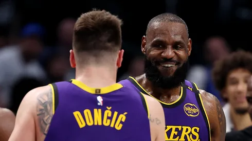 Luka Doncic #77 embraces LeBron James #23 of the Los Angeles Lakers during the fourth quarter against the Dallas Mavericks