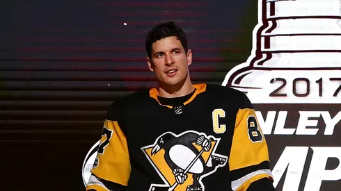 Sidney Crosby #87 of the Pittsburgh Penguins brings the Stanley Cup to the ice before to raising their 2017 championship banner prior to playing the St. Louis Blues at PPG PAINTS Arena on October 4, 2017 in Pittsburgh, Pennsylvania.