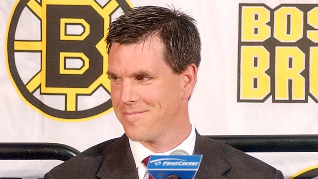 Mike Sullivan, the newly appointed head coach of the Boston Bruins smiles at his family during a news conference June 23, 2003 in Boston, Massachusetts.