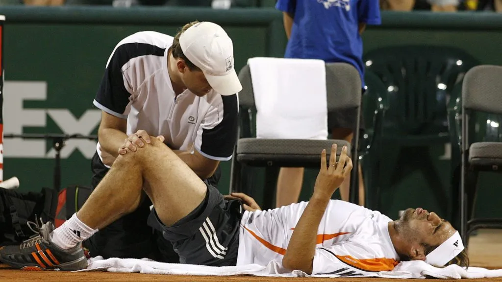 Baghdatis receives medical attention on court in 2006 (Bob Levey/Getty Images)