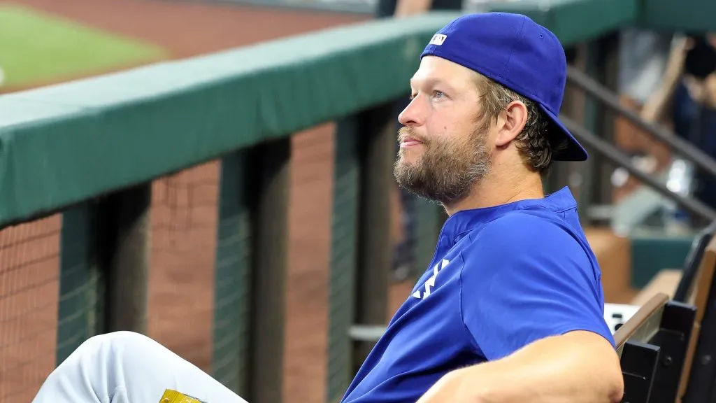 Clayton Kershaw #22 of the Los Angeles Dodgers sits in the dugout before a game against the Texas Rangers