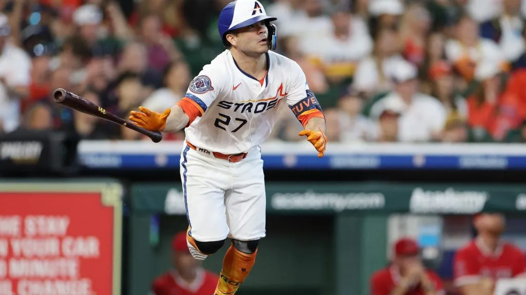 Jose Altuve #27 of the Houston Astros hits a sacrifice fly that scored Mauricio Dubón #14 during the seventh inning against the Los Angeles Angels at Daikin Park on April 13, 2025 in Houston, Texas. (Photo by Alex Slitz/Getty Images)