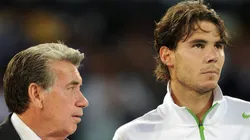 Manolo Santana tries to talk with Rafael Nadal of Spain after losing his final match against Novak Djokovic of Serbia in straight sets during the 2011 Madrid Open.