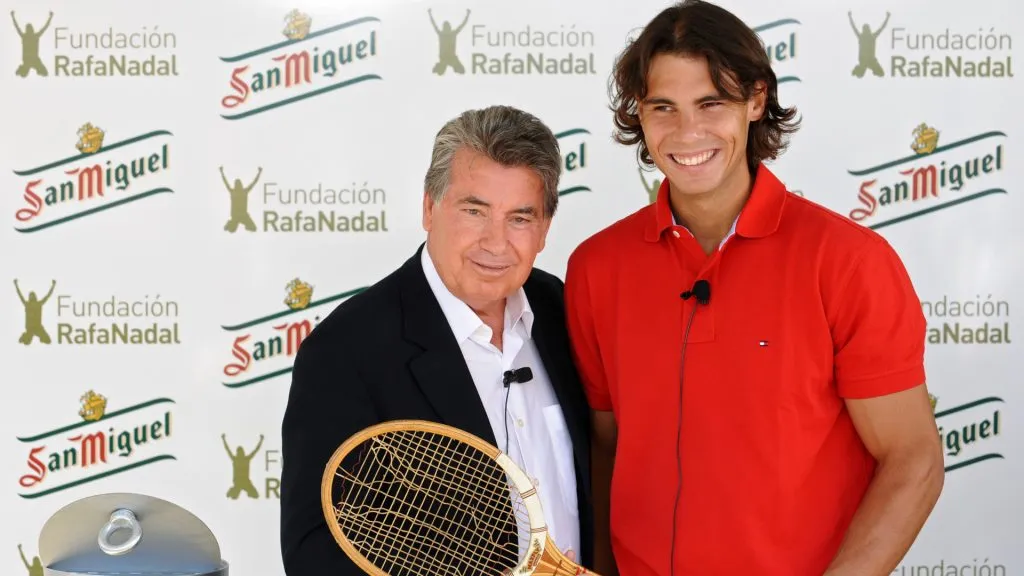 Former tennis great Manolo Santana (L) and Rafael Nadal hold a racket used by Santana in the year he won the Wimbledon Championships. (Jasper Juinen/Getty Images)