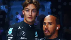 Lewis Hamilton of Great Britain and Mercedes and George Russell of Great Britain and Mercedes look on in the garage during final practice ahead of the F1 Grand Prix of Netherlands at Circuit Zandvoort.