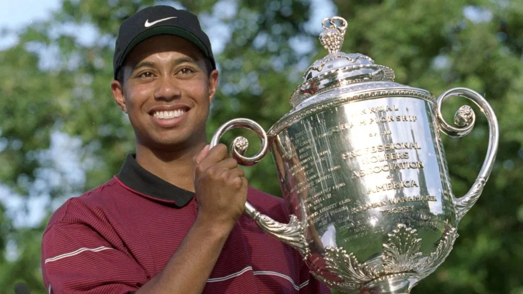 Tiger Woods hoists the Wanamaker Trophy after capturing the PGA Championship in 1999. (Source: Jamie Squire /Allsport – Getty Images)
