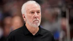 Gregg Popovich of the San Antonio Spurs stands during the playing of the national anthem before the game against the Dallas Mavericks at American Airlines Center on December 23, 2023.