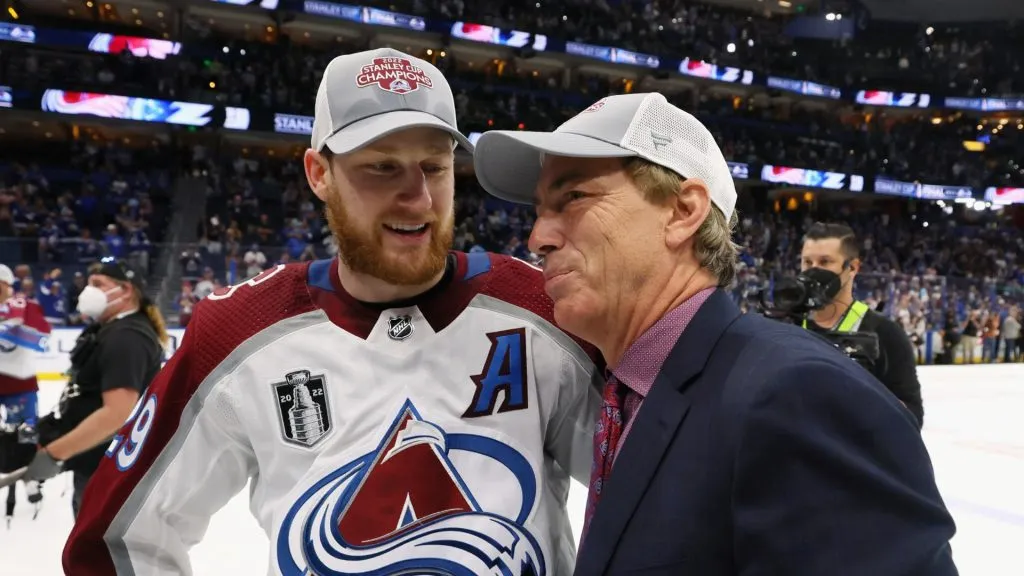Nathan MacKinnon #29 of the Colorado Avalanche and Joe Sakic chat following the series winning victory over the Tampa Bay Lightning in Game Six of the 2022 NHL Stanley Cup Final at Amalie Arena on June 26, 2022 in Tampa, Florida.