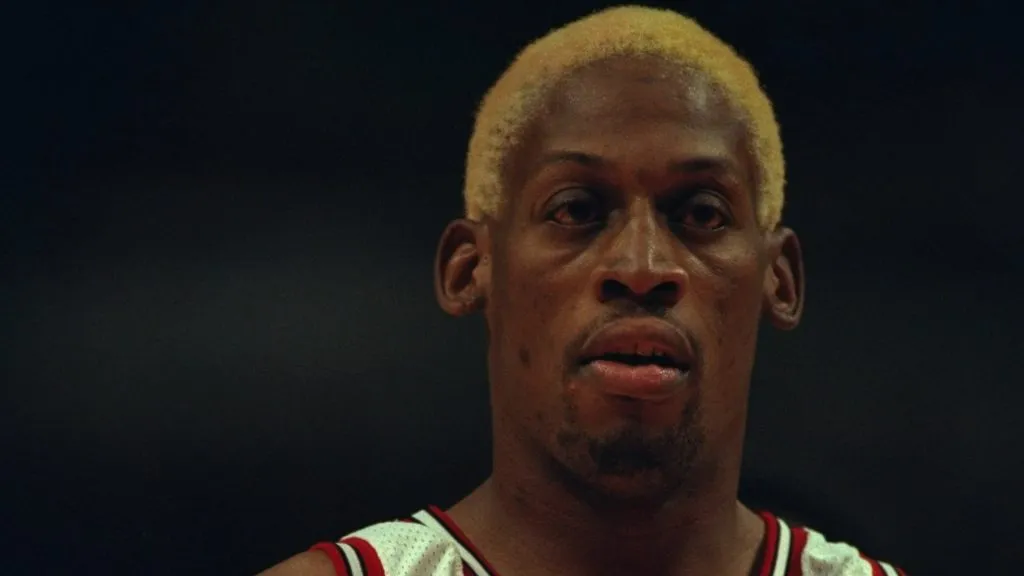 Guard Dennis Rodman #91 of the Chicago Bulls stands on the court at the United Center in 1995. (Source: Jonathan Daniel/Alls – Getty Images)