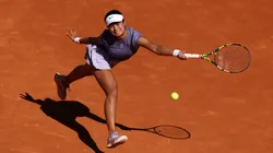 Alexandra Eala of Philippines stretches for a forehand against Iga Swiatek of Poland in the Women's Singles Second Round match during Day Three of the Mutua Madrid Open at La Caja Magica on April 24, 2025 in Madrid, Spain.