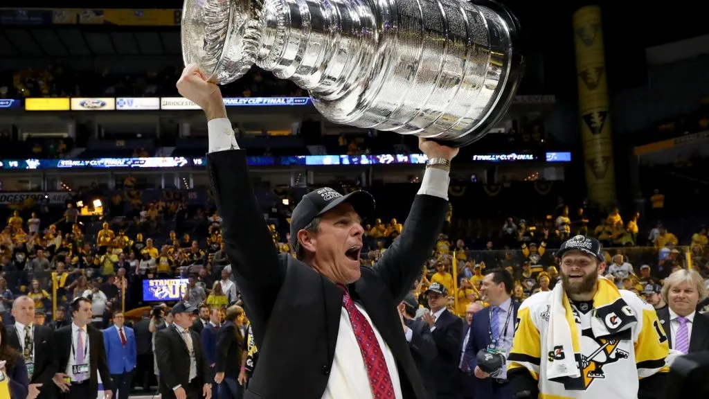 Head coach Mike Sullivan of the Pittsburgh Penguins celebrates with the Stanley Cup Trophy after defeating the Nashville Predators 2-0 in Game Six of the 2017 NHL Stanley Cup Final. (Source: Bruce Bennett/Getty Images)