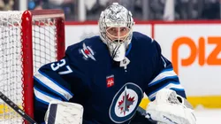 Connor Hellebuyck #37 of the Winnipeg Jets warms up.