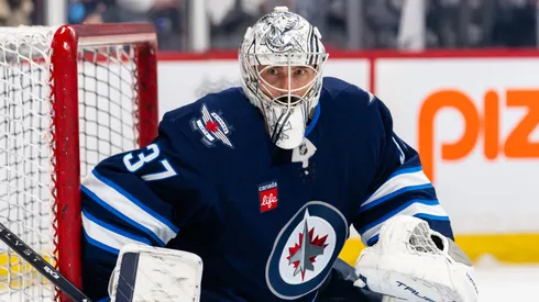 Connor Hellebuyck #37 of the Winnipeg Jets warms up.