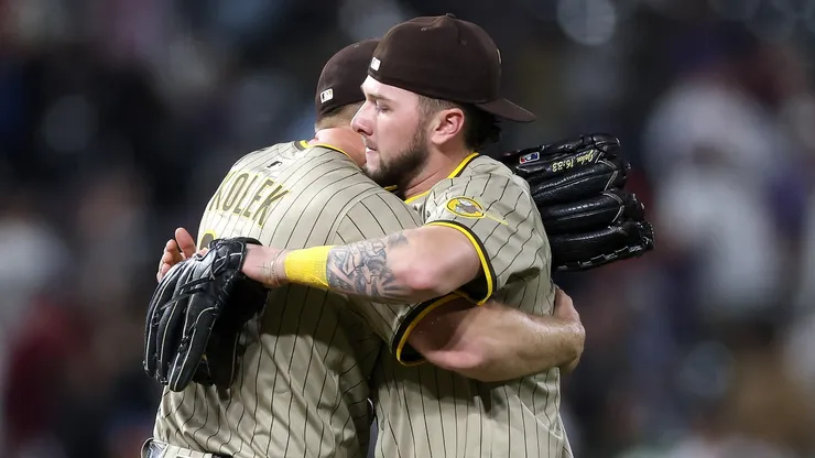 Starting pitcher Stephen Kolek #32 of the San Diego Padres is congratulated by Jackson Merrill #3 after throwing a complete game shutout against the Colorado Rockies at Coors Field on May 10, 2025 in Denver, Colorado.
