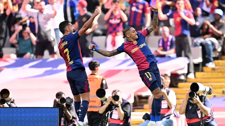 Raphinha of FC Barcelona celebrates scoring his team's third goal with teammate Ferran Torres during the LaLiga match between FC Barcelona and Real Madrid CF at Estadi Olimpic Lluis Companys on May 11, 2025 in Barcelona, Spain.