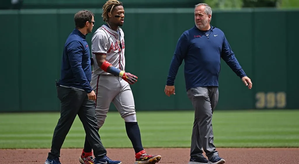 Ronald Acuña Jr. #13 of the Atlanta Braves walks off the field with trainers on May 26, 2024 in Pittsburgh, Pennsylvania. (Photo by Justin Berl/Getty Images)