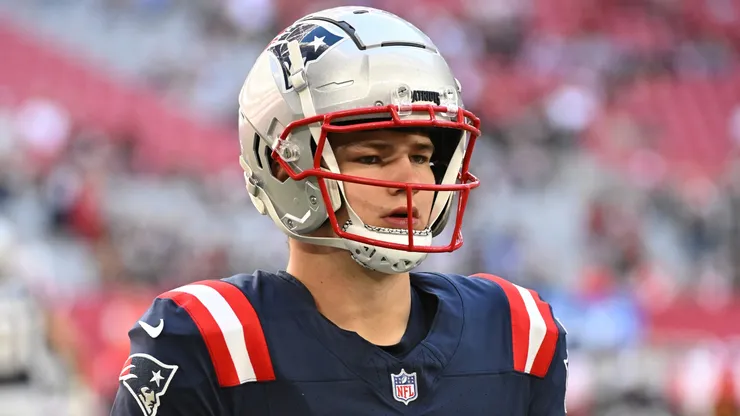 Drake Maye #10 of the New England Patriots walks the field prior to the game against the Arizona Cardinals at State Farm Stadium on December 15, 2024 in Glendale, Arizona.