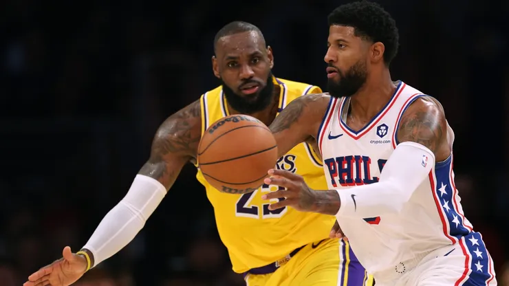 Paul George #8 of the Philadelphia 76ers passes as he is guarded by LeBron James #23 of the Los Angeles Lakers
