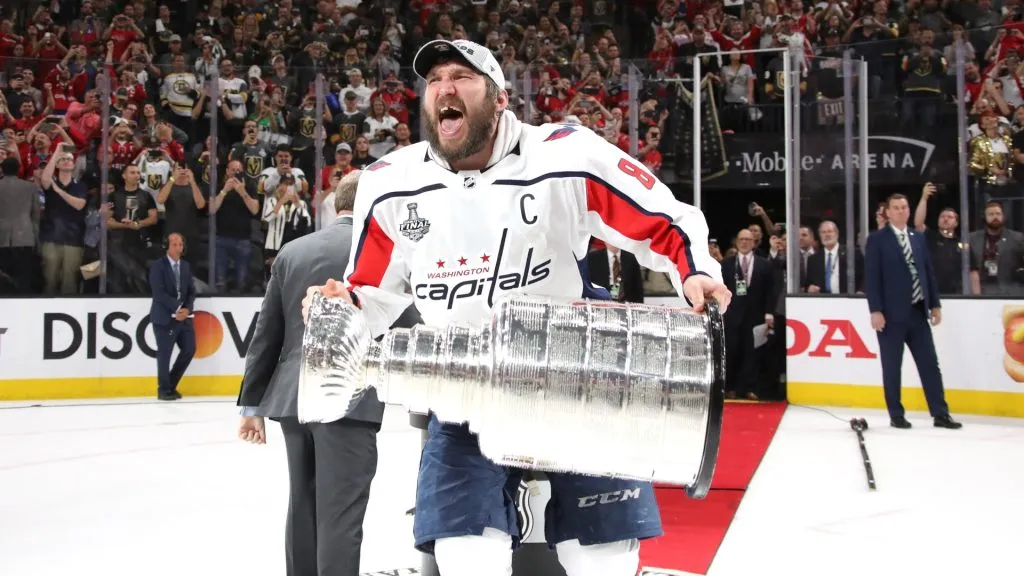 Alex Ovechkin #8 of the Washington Capitals hoists the Stanley Cup after his team defeated the Vegas Golden Knights 4-3 in Game Five of the 2018 NHL Stanley Cup Final. (Source: Bruce Bennett/Getty Images)