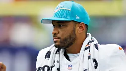 Tua Tagovailoa #1 of the Miami Dolphins greets players coming off the field during a preseason game against the Houston Texans at NRG Stadium on August 19, 2023 in Houston, Texas.