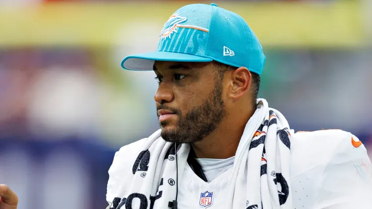 Tua Tagovailoa #1 of the Miami Dolphins greets players coming off the field during a preseason game against the Houston Texans at NRG Stadium on August 19, 2023 in Houston, Texas.