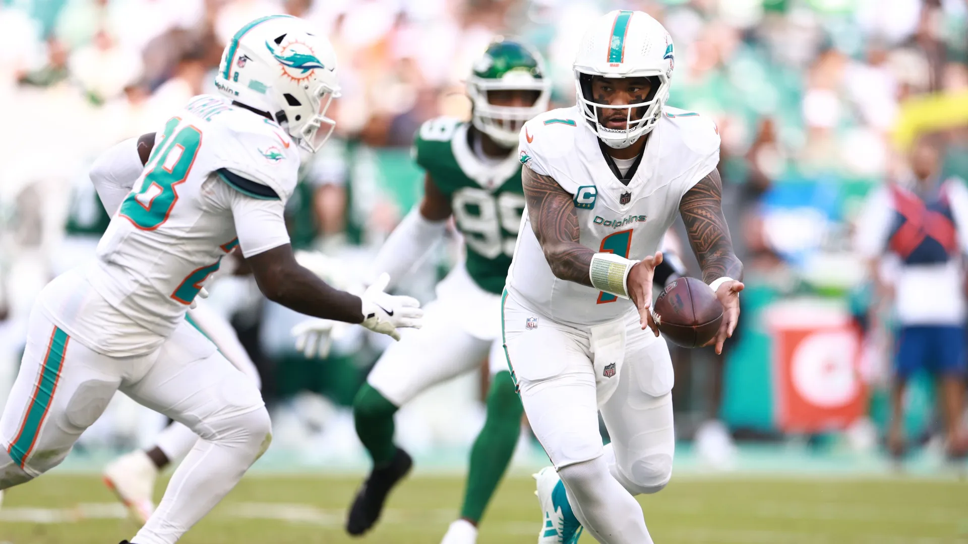 Tua Tagovailoa running the ball to Achane