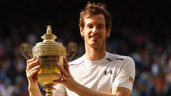 Andy Murray of Great Britain lifts the Wimbledon trophy following victory over Milos Raonic in the final. (Julian Finney/Getty Images)