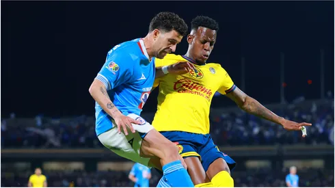 Ignacio Rivero of Cruz Azul battles for possession with Cristian Borja of America