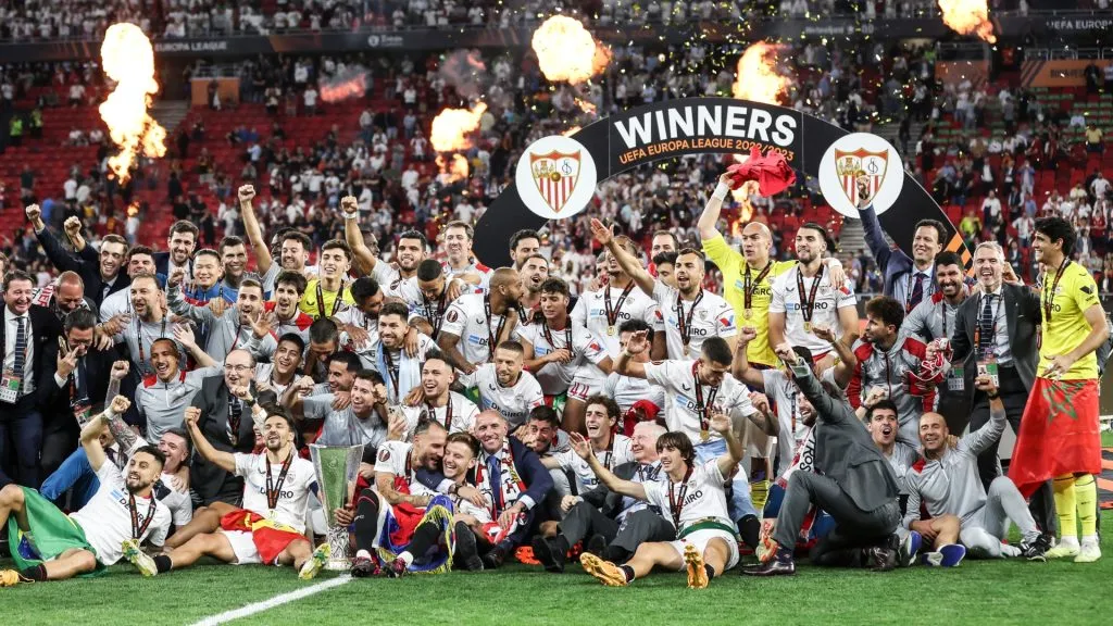 Team of Sevilla FC pose with a trophy after winning the UEFA Europa League 2022/23 final match between Sevilla FC and AS Roma at Puskas Arena on May 31, 2023. (Source: Maja Hitij/Getty Images)