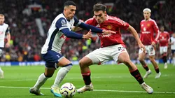 Pedro Porro of Tottenham Hotspur is challenged by Manuel Ugarte of Manchester United during the Premier League match between Manchester United FC and Tottenham Hotspur FC at Old Trafford on September 29, 2024 in Manchester, England.