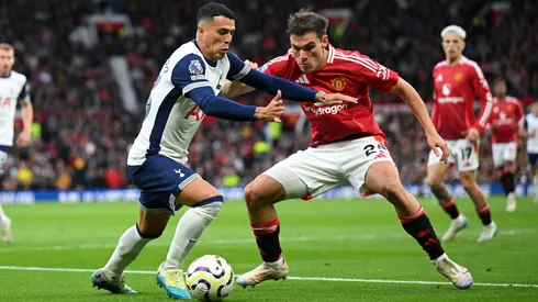 Pedro Porro of Tottenham Hotspur is challenged by Manuel Ugarte of Manchester United during the Premier League match between Manchester United FC and Tottenham Hotspur FC at Old Trafford on September 29, 2024 in Manchester, England.