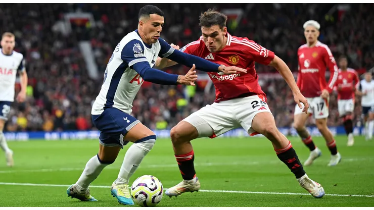 Pedro Porro of Tottenham Hotspur is challenged by Manuel Ugarte of Manchester United during the Premier League match between Manchester United FC and Tottenham Hotspur FC at Old Trafford on September 29, 2024 in Manchester, England.