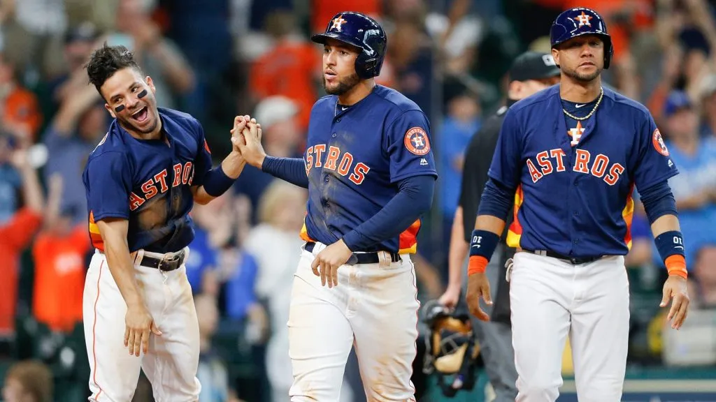 George Springer #4 of the Houston Astros celebrates with Jose Altuve #27 and Yuli Gurriel #10 after scoring on a walk in the second inning against the Kansas City Royals in 2017. (Source: Bob Levey/Getty Images)