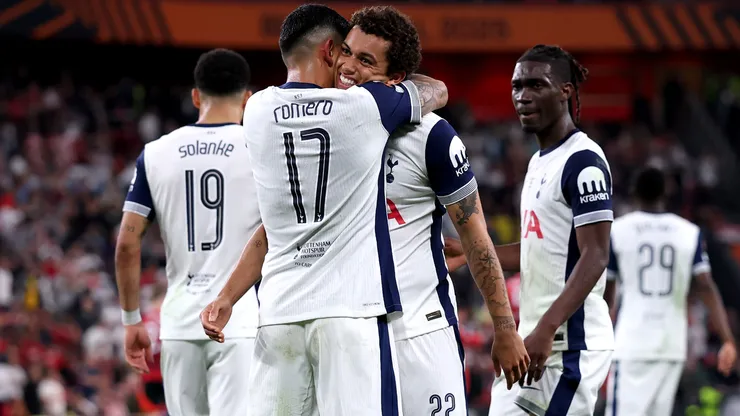 Brennan Johnson of Tottenham Hotspur celebrates scoring his team's first goal with teammate Cristian Romero.